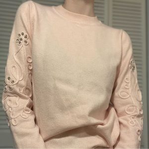 NWOT pink sweater with sleeve detail and ruffle hem